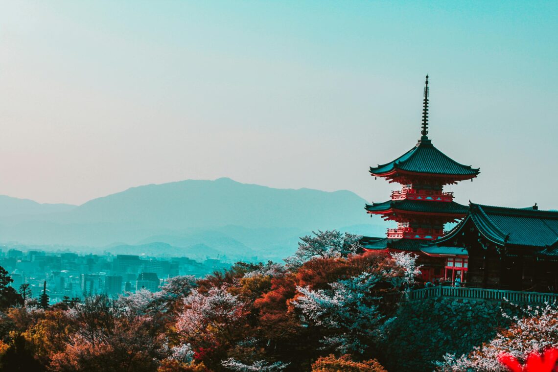 red-and-black-temple-surrounded-by-trees-photo