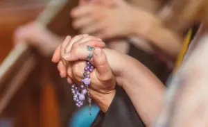 People holding each other's Hands while Praying