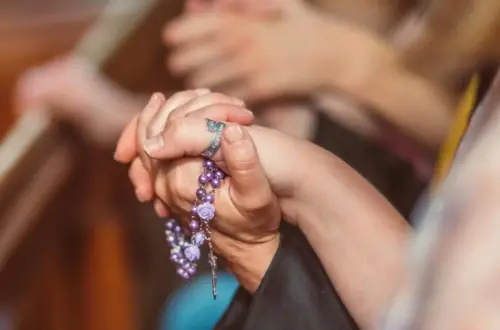 People holding each other's Hands while Praying